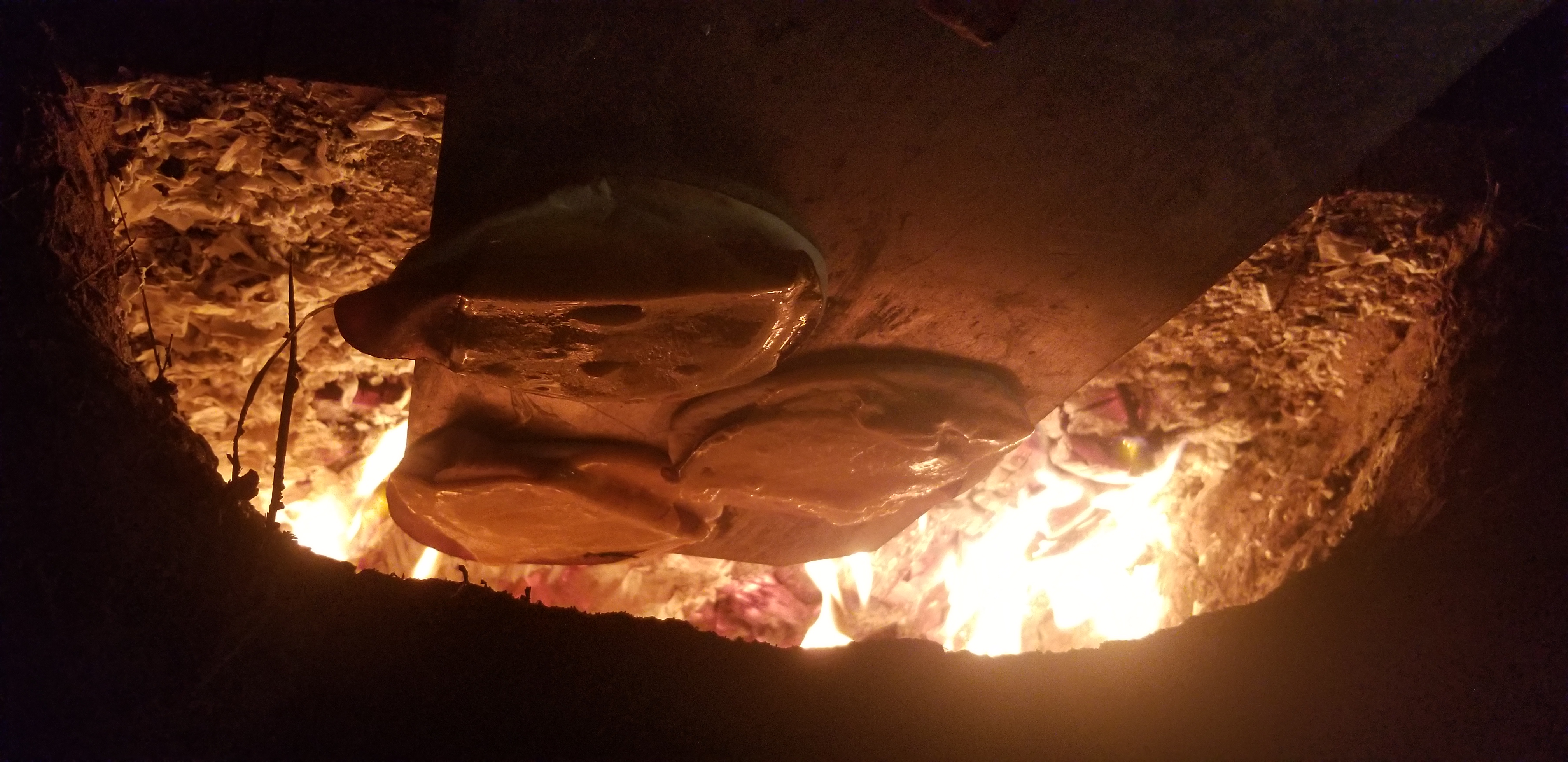 Firing an earthen cob oven