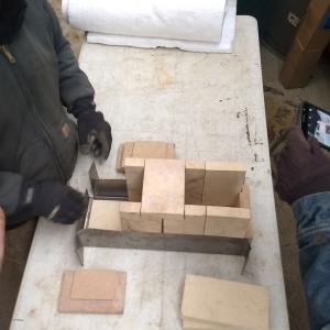 Positioning the bricks for the burn chamber